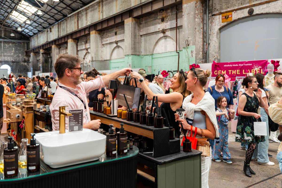Shoppers browsing a busy vendor stall at The Big Design Market inside Carriageworks in Sydney