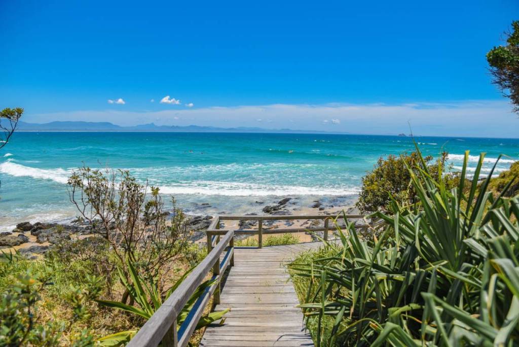Coastal walking path overlooking bright turquoise waters at Cape Byron in Byron Bay