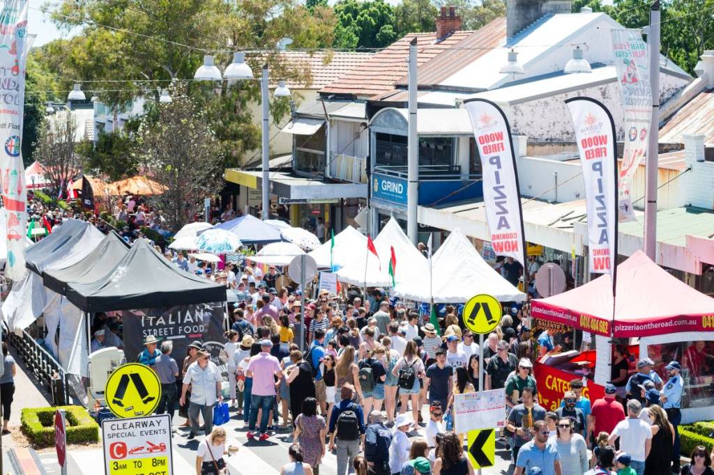 Crowds pack Norton Street in Leichhardt during the Italian Festa, surrounded by food stalls and market tents