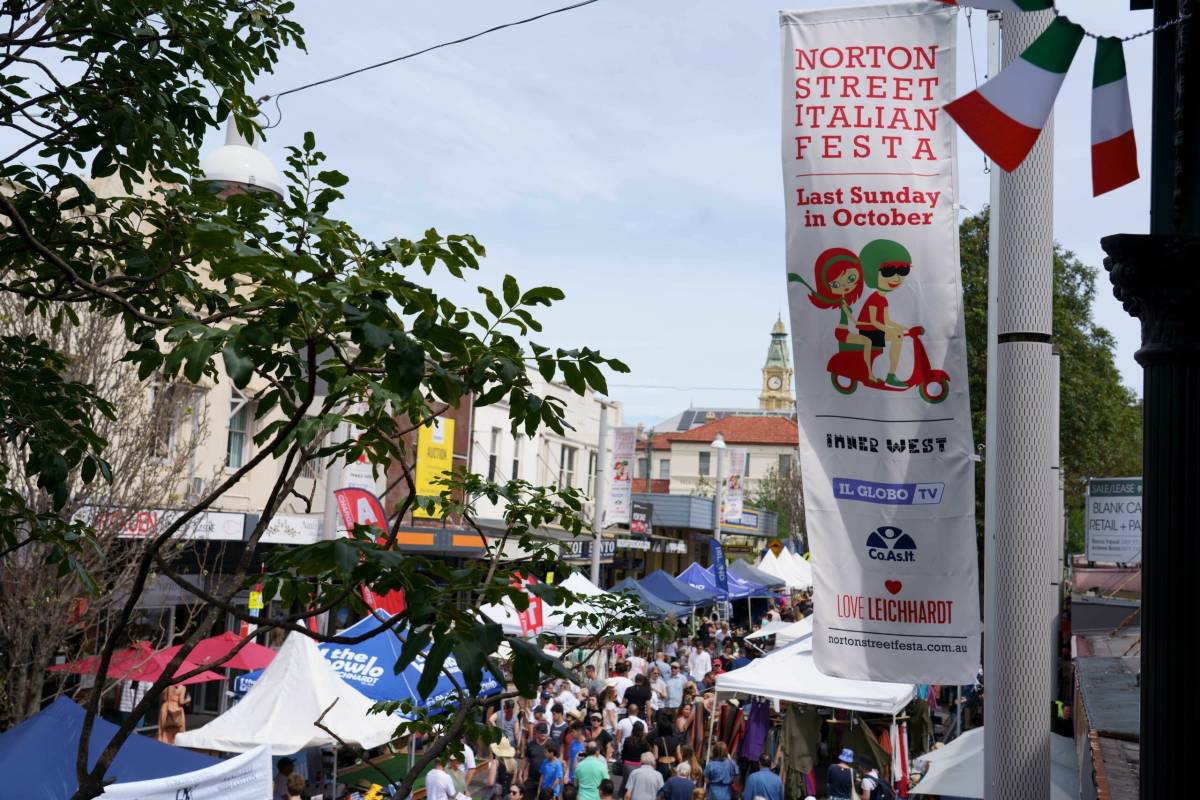 Crowds fill Norton Street in Leichhardt during the annual Norton Street Italian Festa, with market stalls and Italian flags lining the street