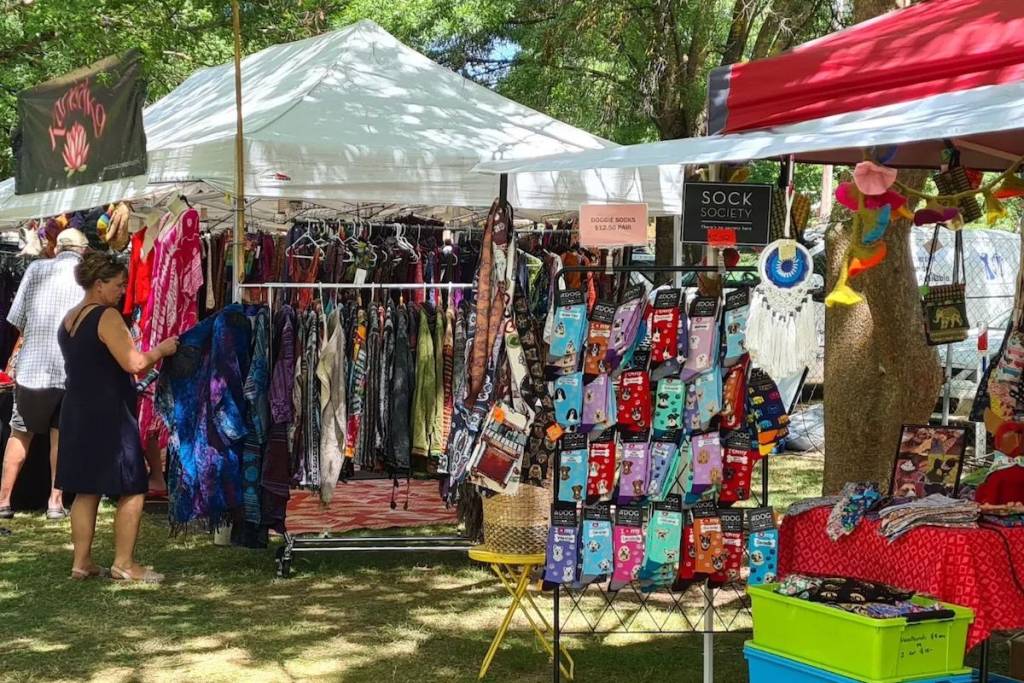 Shoppers browsing clothing, accessories and handmade goods at outdoor stalls at the Milton Showground Market