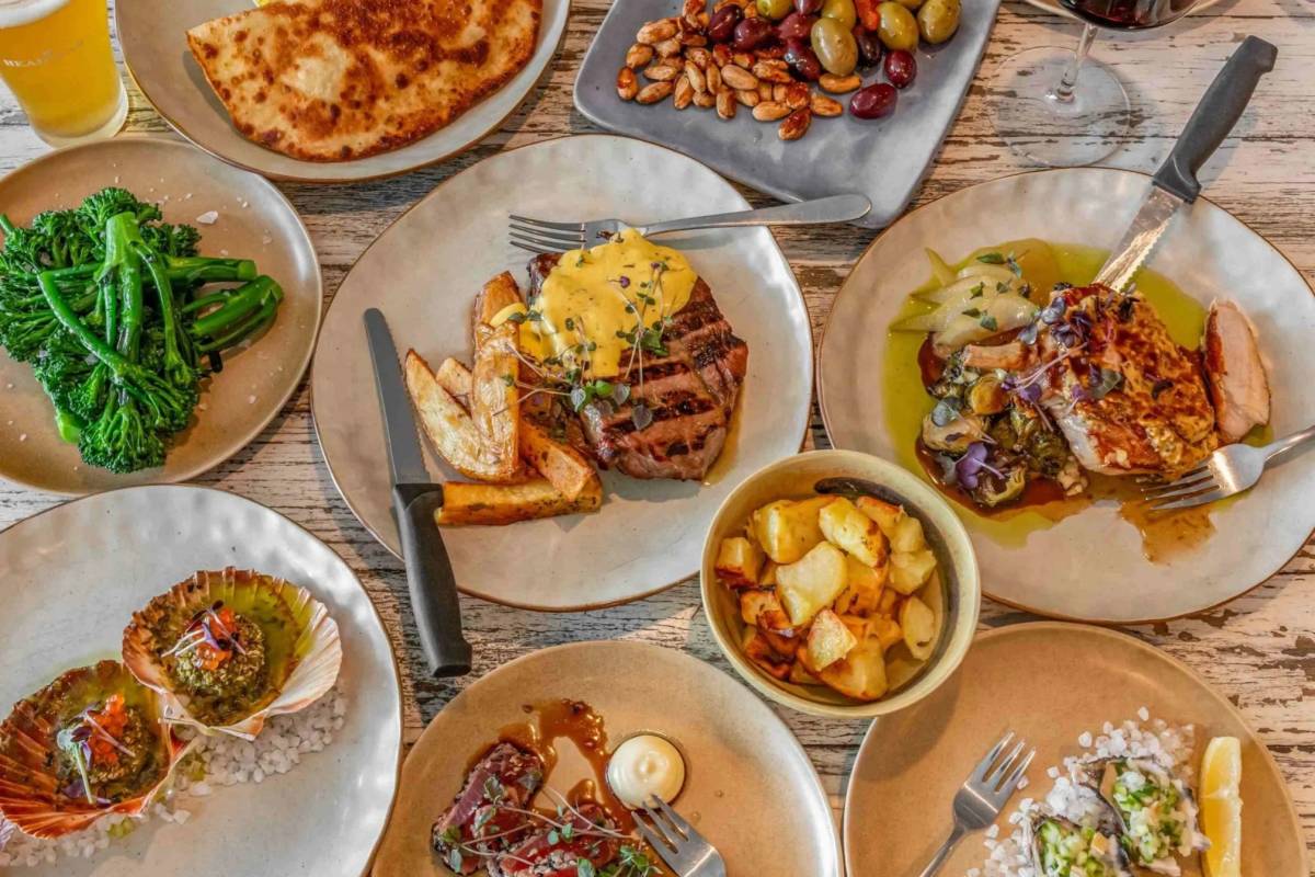 A spread of seafood, meat, vegetables and shared plates at a restaurant in Huskisson
