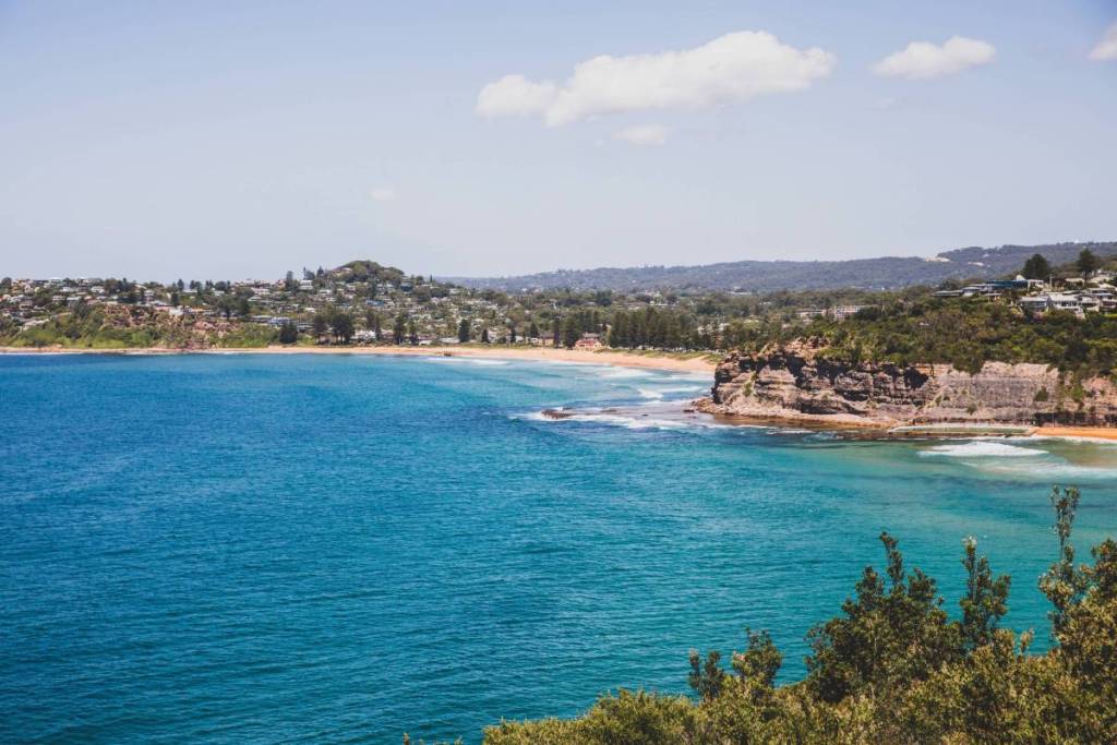 Sweeping coastal views from Bilgola lookout, with turquoise ocean waters, rocky headlands and the beach in the distance