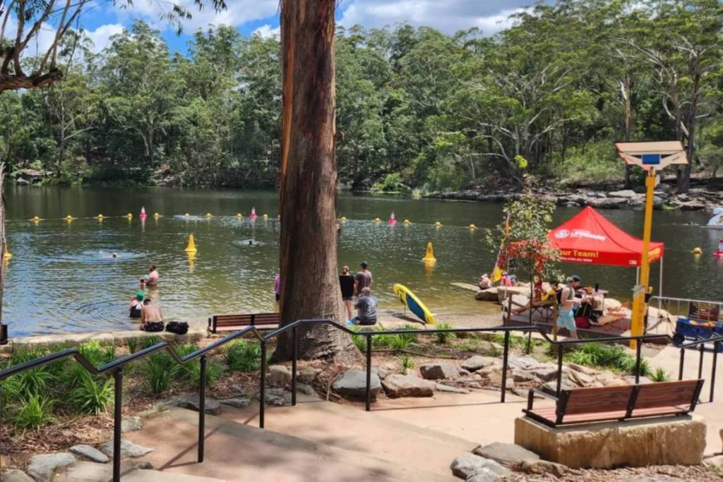 people at lake parramatta in sydney: drinking reservoir turned swimming enclosure spot