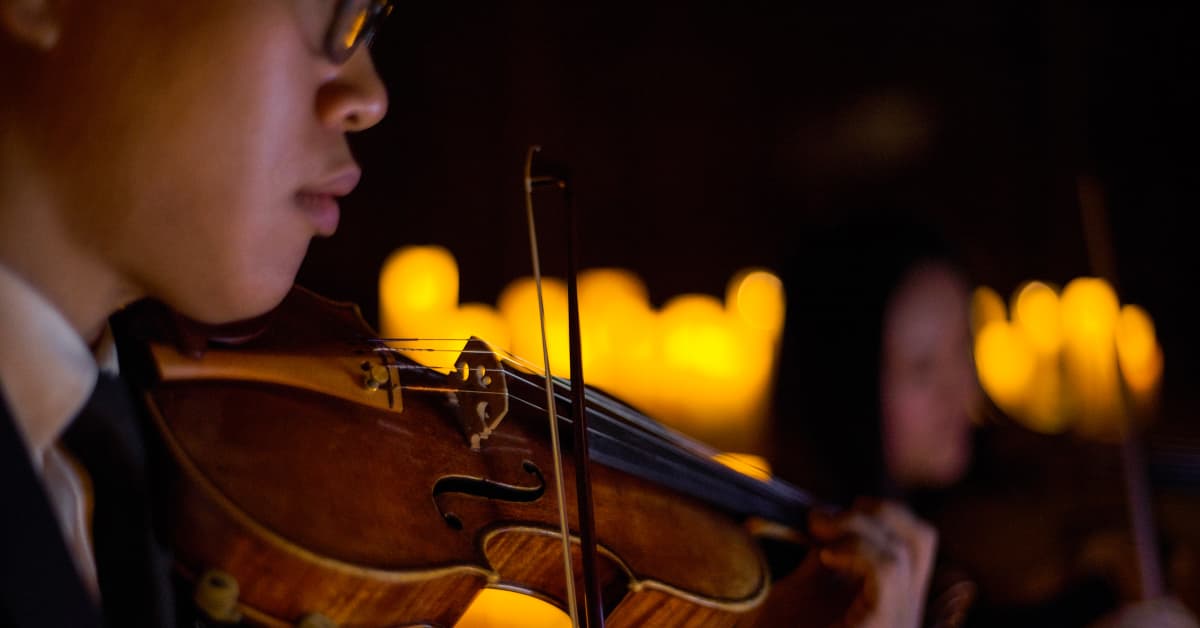 Close up of a musician playing the violin at a Candlelight concert