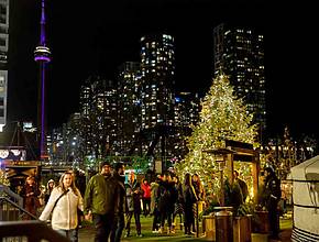 A Beloved Holiday Festival Returns To Toronto With A 120-Foot Light Tunnel, Outdoor Curling, And A Speakeasy Martini Bar