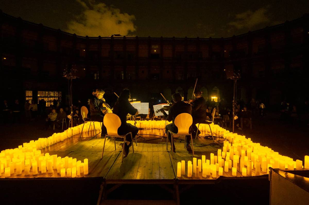 A string quartet performing at an open-air Candlelight concert