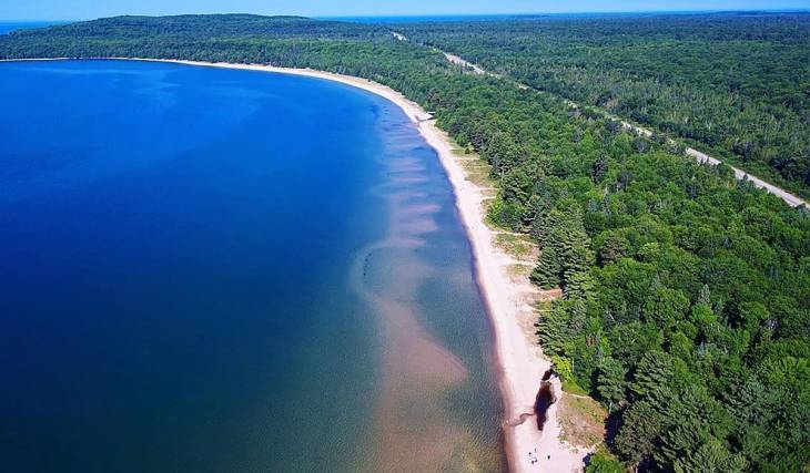 This underrated Ontario beach with 3km of white sand and clear blue water is the ultimate summer road trip from Toronto