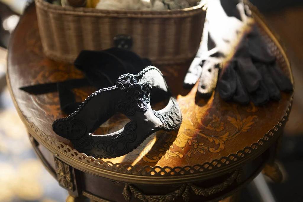mask sits on regal table as part of bridgerton period drama set