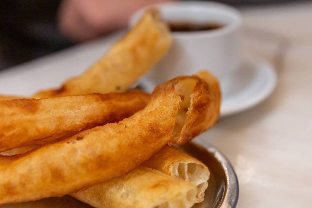 Why are churros called calentitos in Seville?