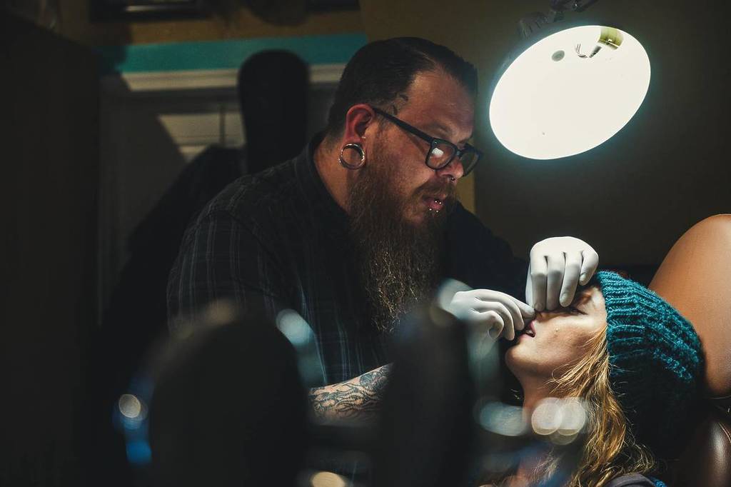 piercer in the piercing studio with a customer