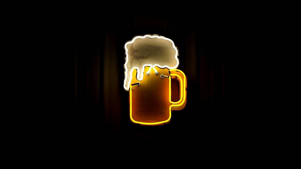 leuchtschild, das ein schäumnedes bier zeigt