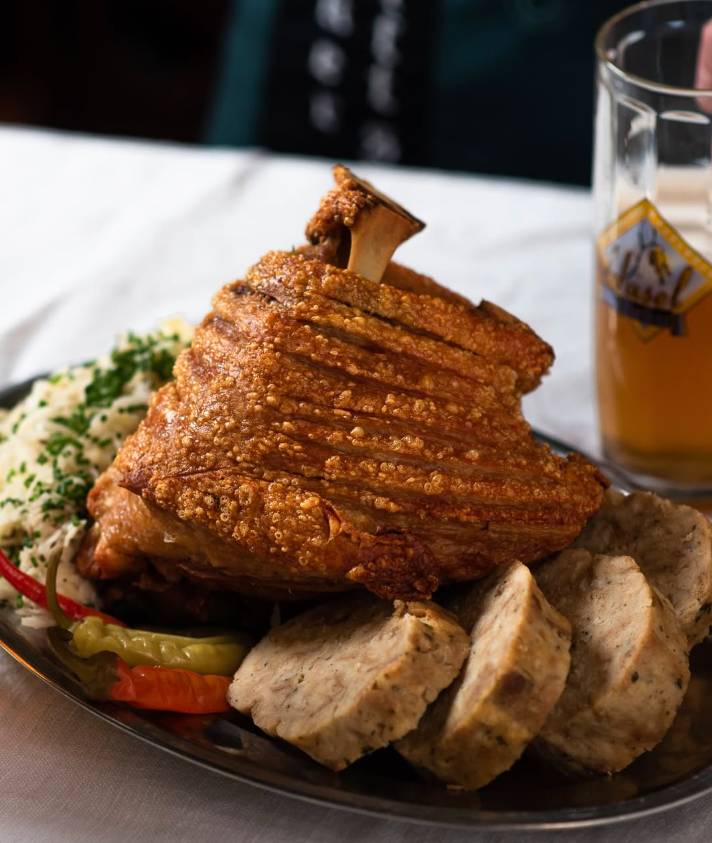 Whole roast pork knuckle for three people with various side dishes